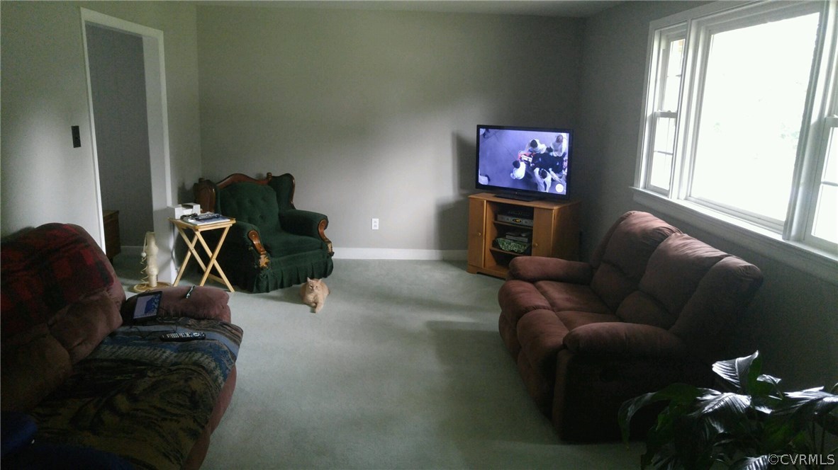 10901 Surry Road Chester, VA 23831 - Photo 4 of 24 a living room with furniture a window and a flat screen tv