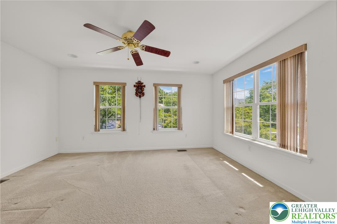 4345 Creek Road Allentown, PA 18104 - Photo 25 of 33 Well-lit room features soft carpeting, bright windows, and a ceiling fan for comfort.