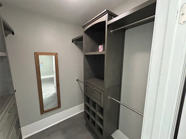 a spacious bathroom with a double vanity sink a mirror and a toilet