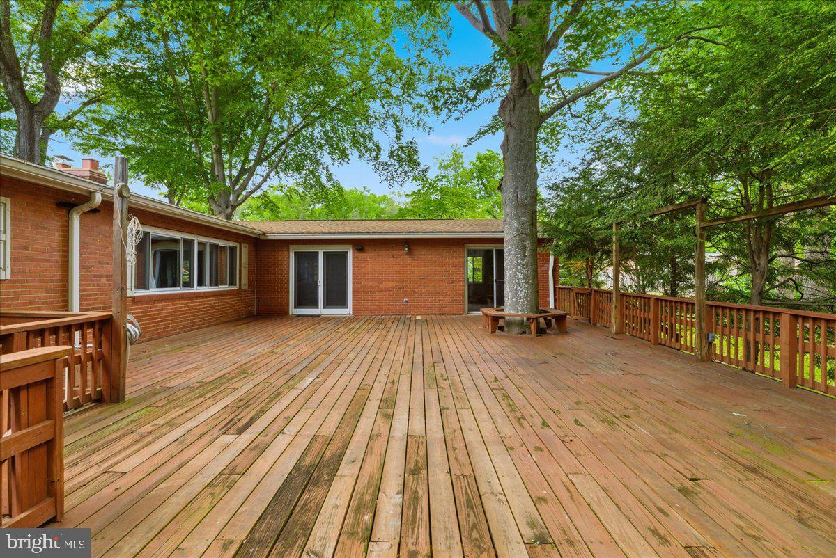 18309 Cabin Road Triangle, VA 22172 - Photo 20 of 42 a view of house with deck outdoor seating and yard