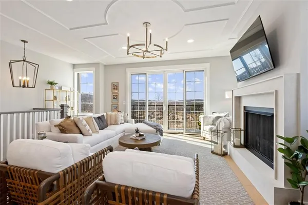 a living room with furniture flower pot and a fireplace
