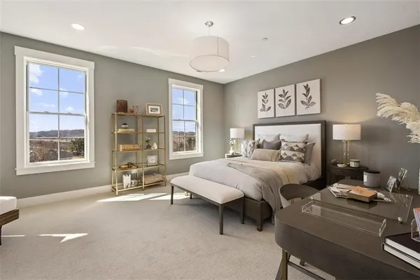 a bedroom with furniture and a large window