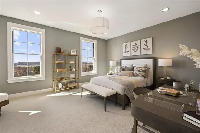 a bedroom with furniture and a large window