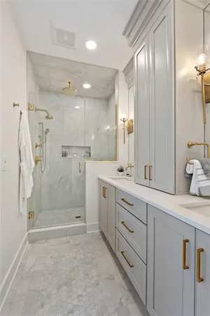a bathroom with a granite countertop sink mirror and shower