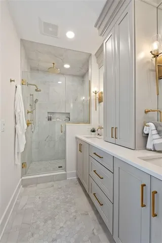 a bathroom with a granite countertop sink mirror and shower