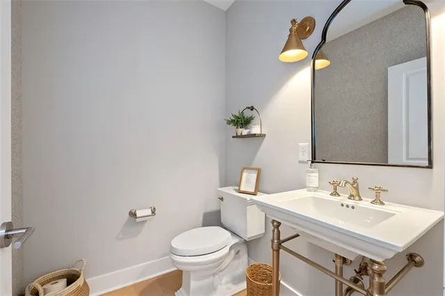 a bathroom with a sink mirror and toilet