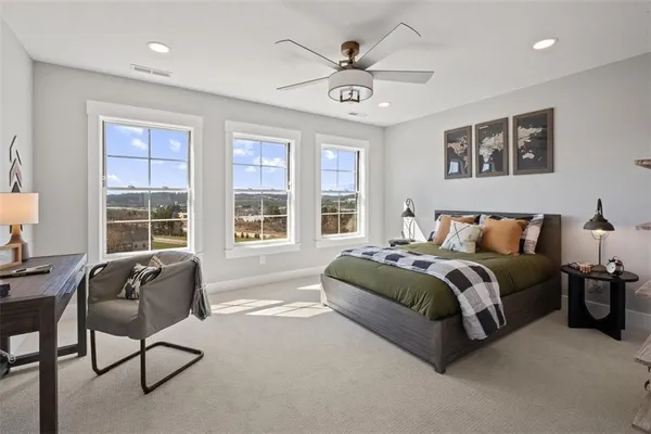 a spacious bedroom with a bed and glass window
