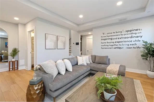 a living room with furniture and a potted plant
