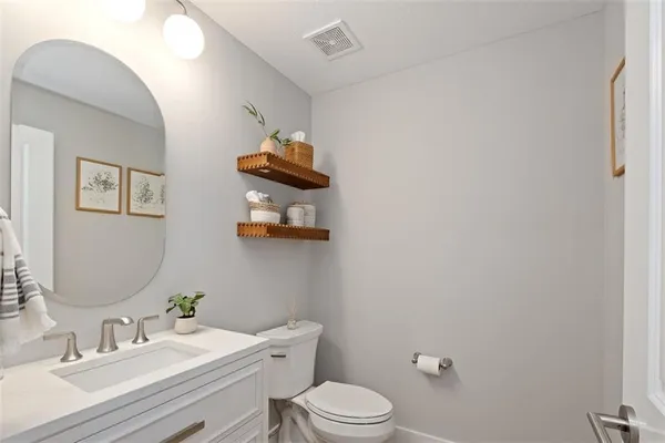a bathroom with a sink mirror and toilet