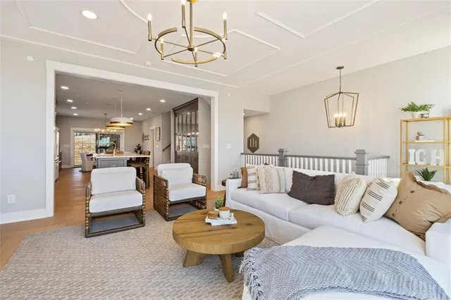 a living room with furniture and a chandelier