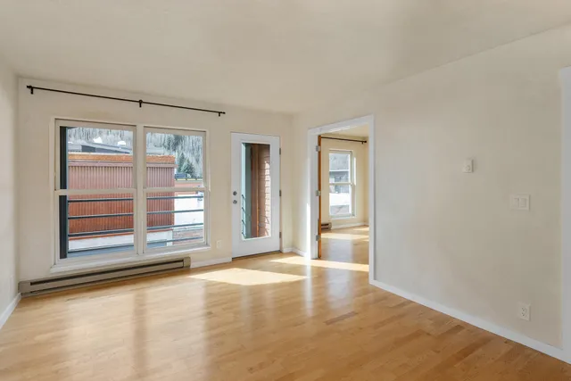 a kitchen with white cabinets and white appliances