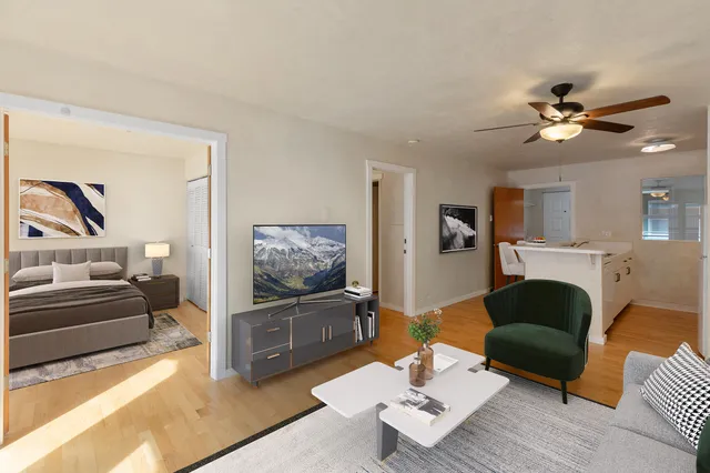 a bedroom with a bed and a painting on the wall