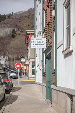 a view of a street with retail shops