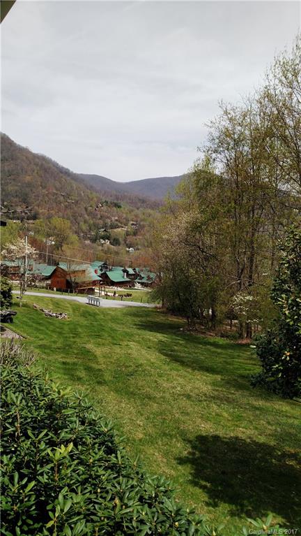 444 Stoney Ridge Loop, Unit 50 Maggie Valley, NC 28751 - Photo 13 of 19 a view of a grassy field with mountains in the background