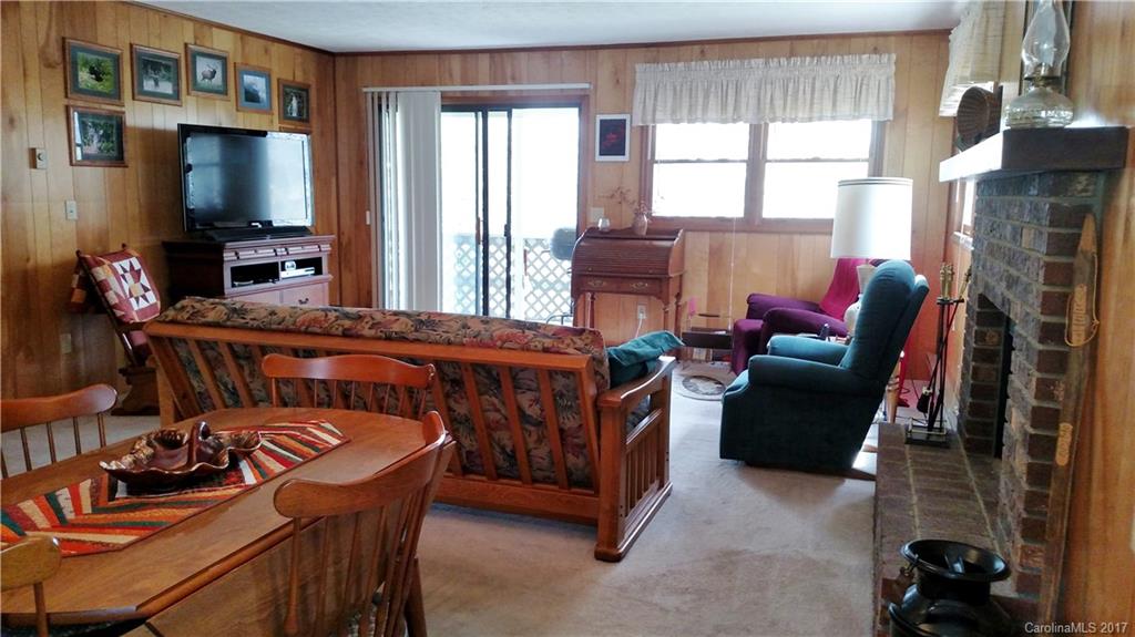 444 Stoney Ridge Loop, Unit 50 Maggie Valley, NC 28751 - Photo 6 of 19 a living room with furniture a flat screen tv and a window