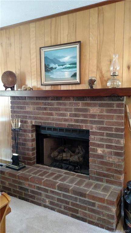 444 Stoney Ridge Loop, Unit 50 Maggie Valley, NC 28751 - Photo 8 of 19 a living room with a fireplace and a large window