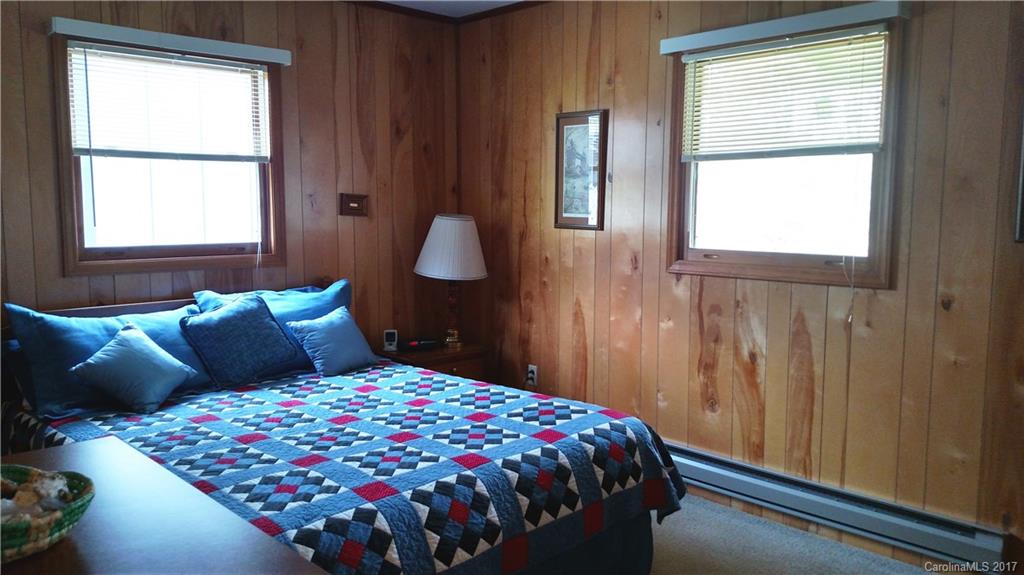 444 Stoney Ridge Loop, Unit 50 Maggie Valley, NC 28751 - Photo 9 of 19 a bedroom with a bed and window