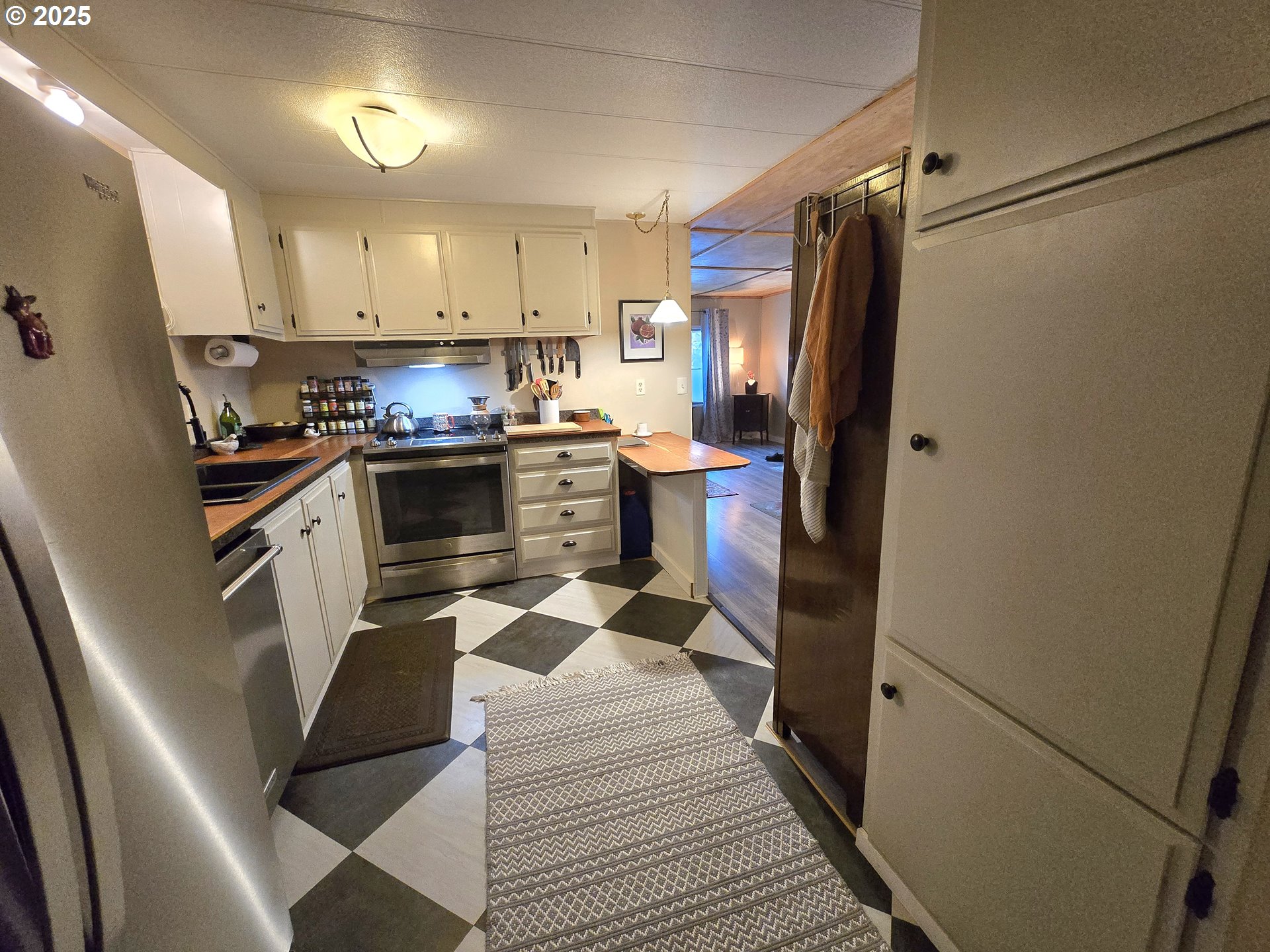 1475 Green Acres Road Eugene, OR 97408 - Photo 11 of 17 a kitchen with stainless steel appliances a refrigerator a sink a stove a microwave and island