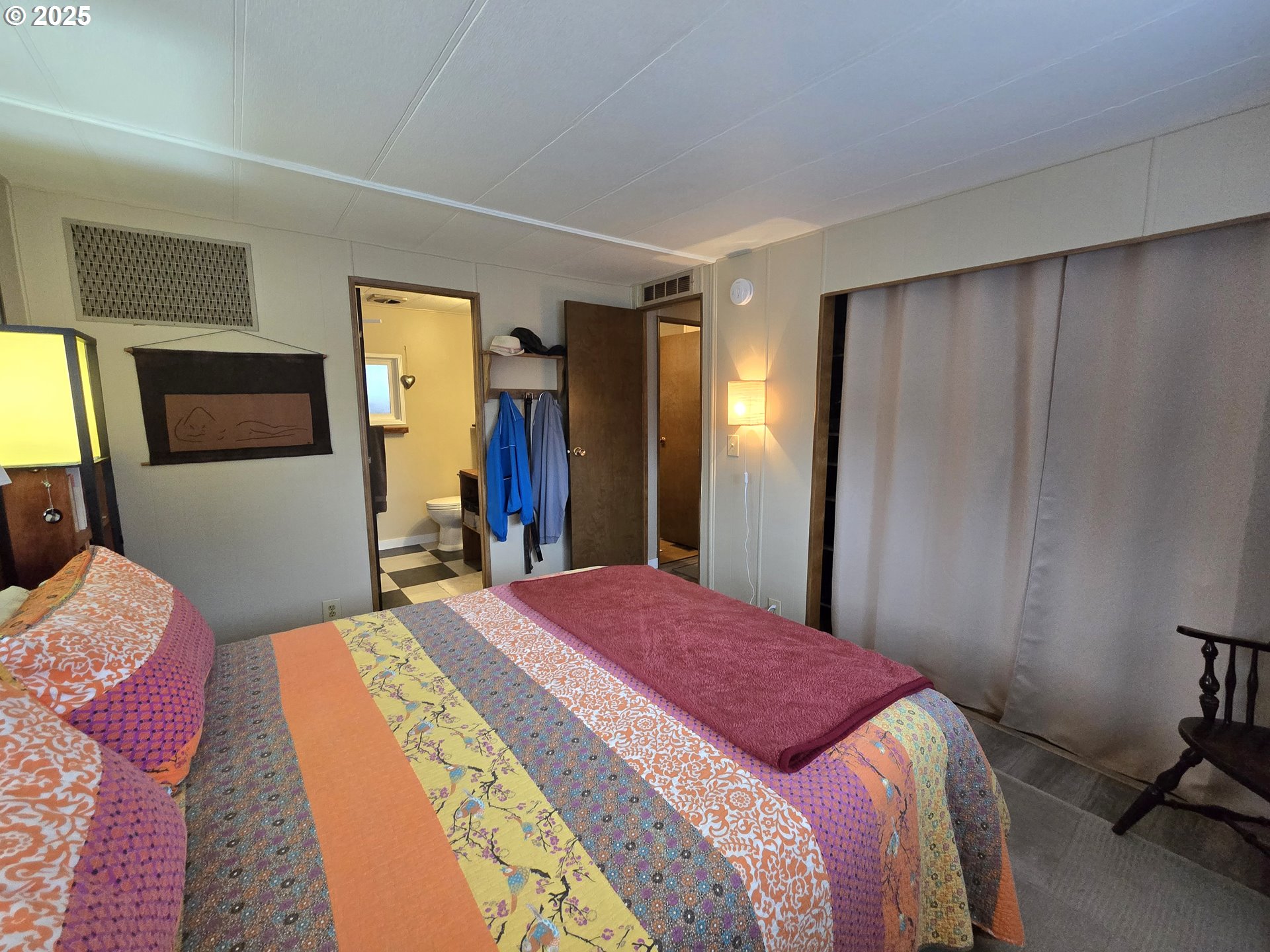 1475 Green Acres Road Eugene, OR 97408 - Photo 9 of 17 a bed room with a bed and a mirror