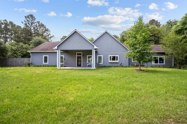a front view of house with yard and green space