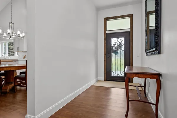 a view of an entryway with wooden floor and a front door