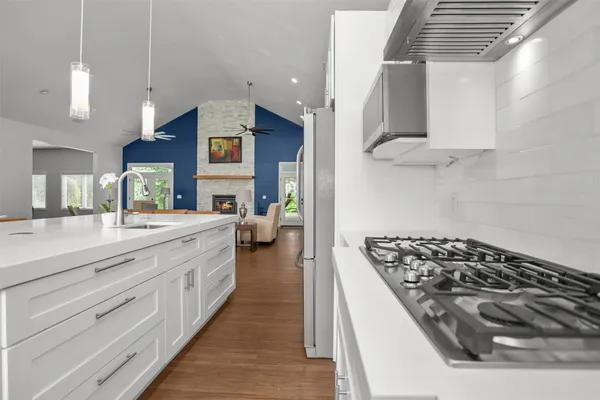 a kitchen with stainless steel appliances granite countertop a stove and a sink