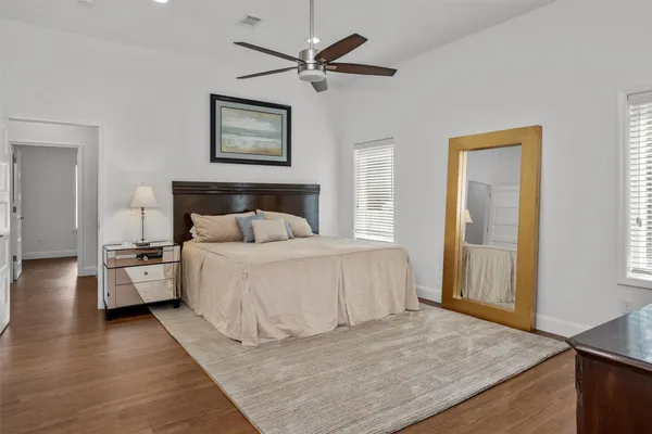a bedroom with a large bed and a chandelier