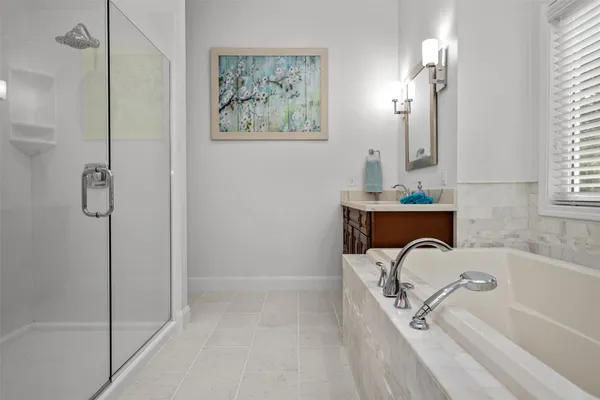 a bathroom with a tub and shower