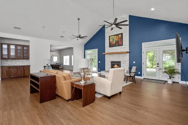 a living room with fireplace furniture and a wooden floor