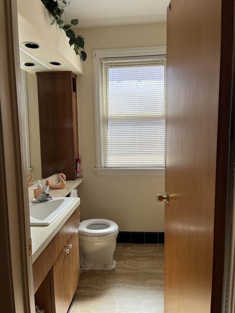 2522 South 3rd Avenue North Riverside, IL 60546 - Photo 12 of 34 a bathroom with a granite countertop sink toilet and mirror