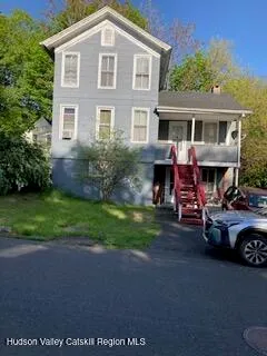 a view of a house with a yard and a fire pit