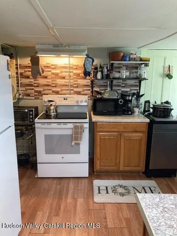 a kitchen with stainless steel appliances kitchen island a stove a sink dishwasher and cabinets