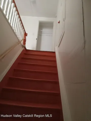 a bedroom with a bed and a flat tv screen on dresser