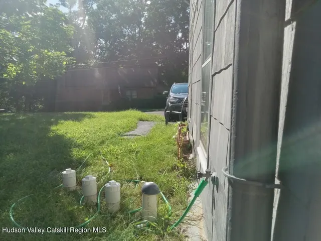 a backyard of a house with lots of green space and outdoor seating