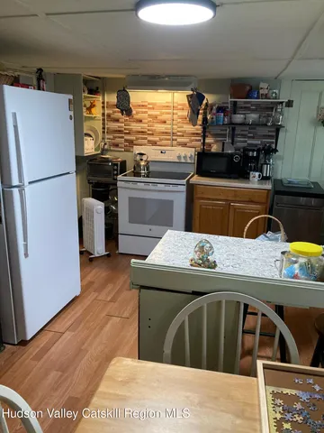 a kitchen with a stove a refrigerator and a stove top oven