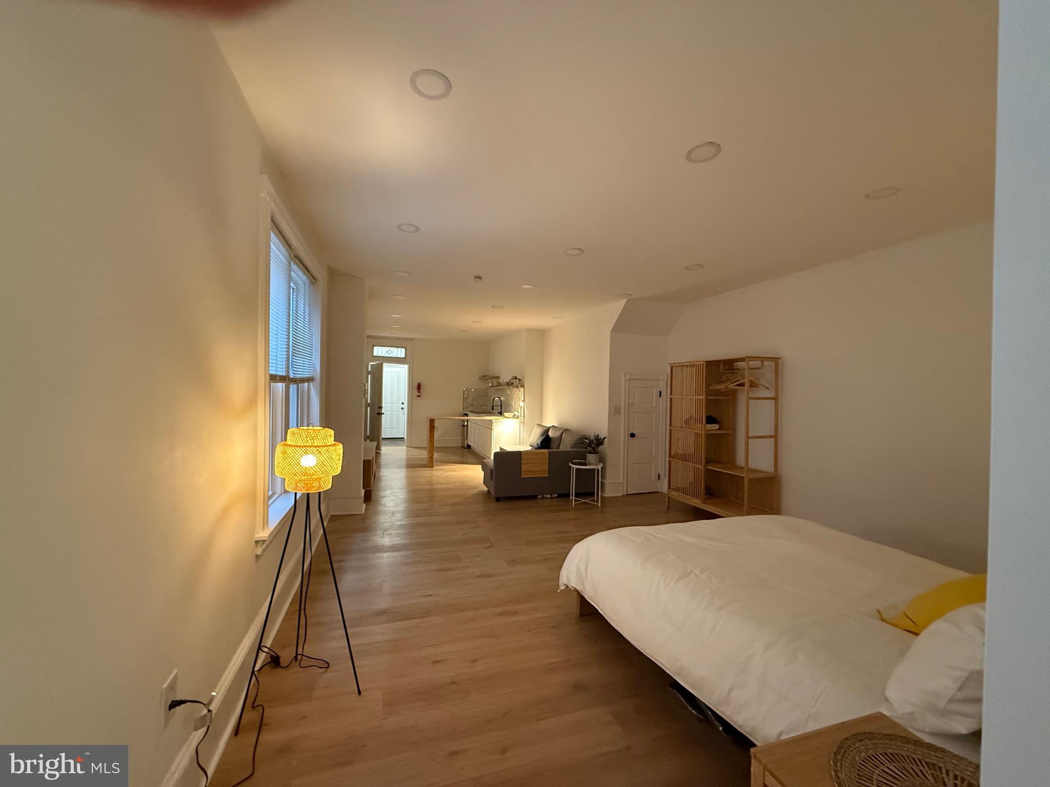 114 South 58th Street, Unit 1 Philadelphia, PA 19139 - Photo 12 of 15 a bed room with a bed and a chandelier