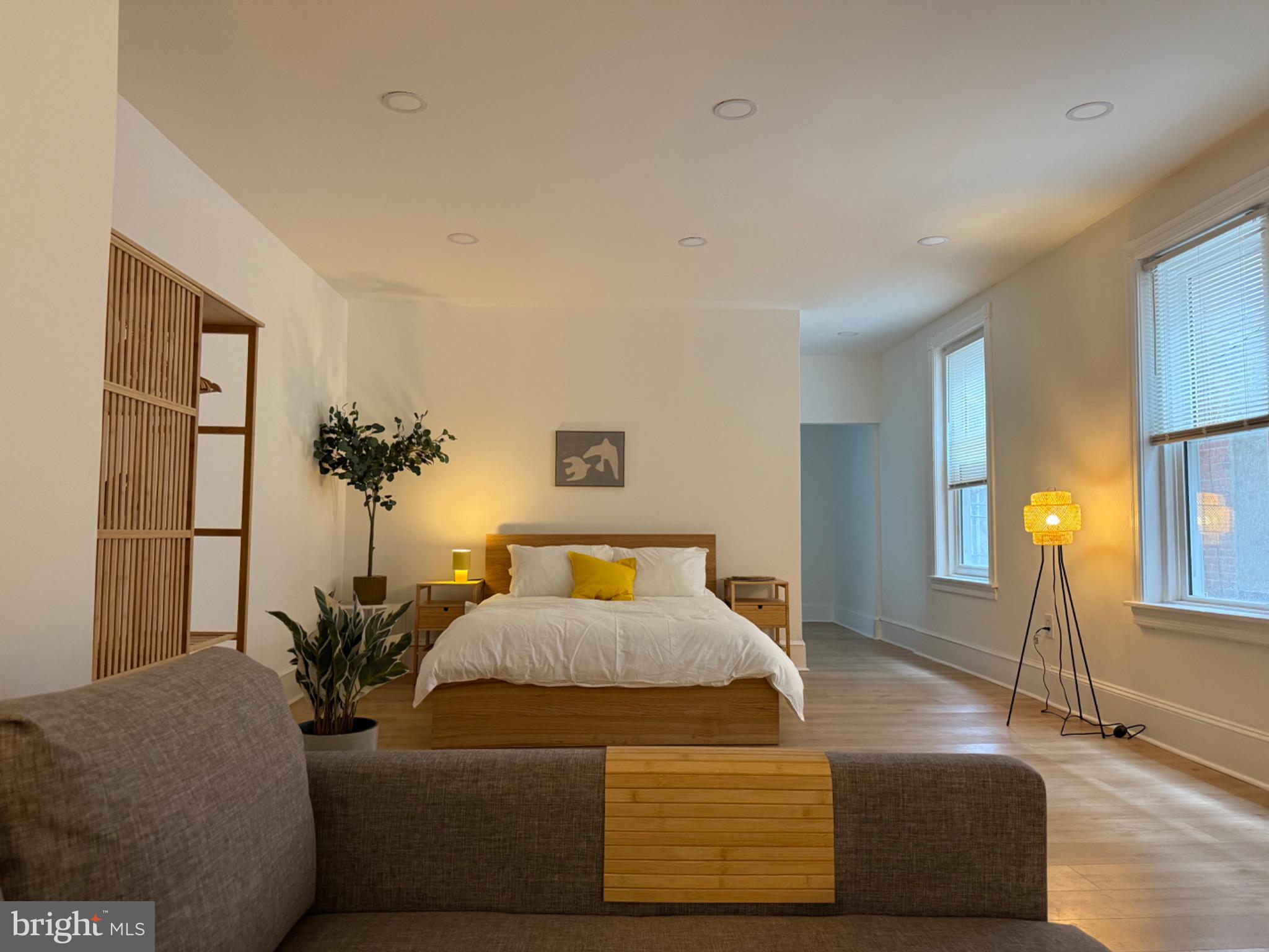 114 South 58th Street, Unit 1 Philadelphia, PA 19139 - Photo 2 of 15 a bedroom with a bed and a couch