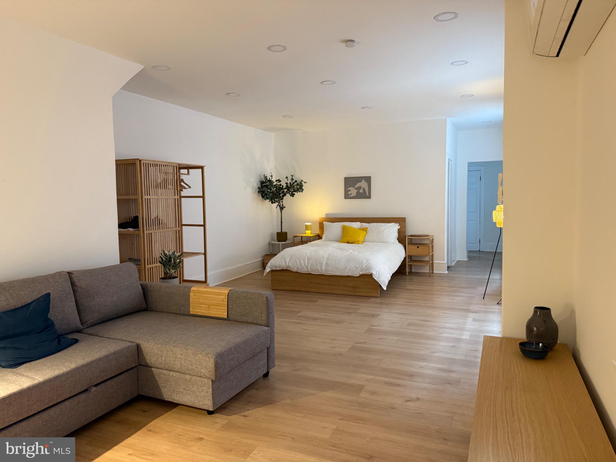 114 South 58th Street, Unit 1 Philadelphia, PA 19139 - Photo 4 of 15 a bedroom with furniture and a couch