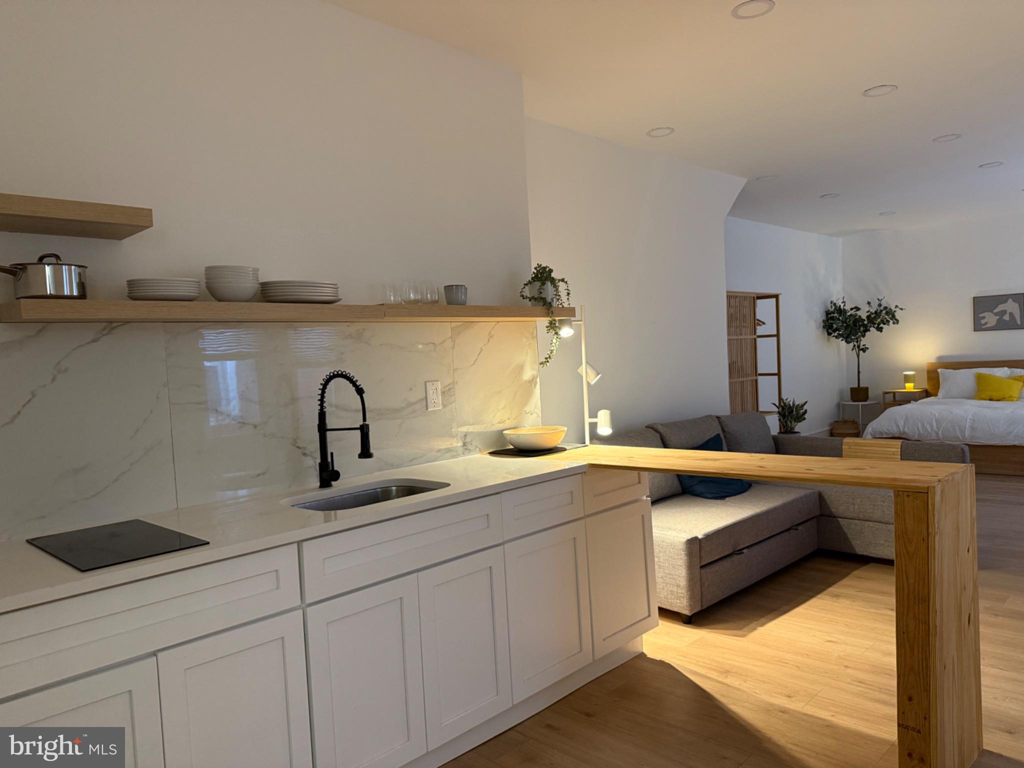 114 South 58th Street, Unit 1 Philadelphia, PA 19139 - Photo 6 of 15 a kitchen with a sink and white cabinets