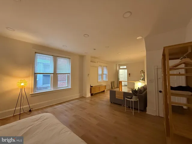 a bedroom with furniture and a window