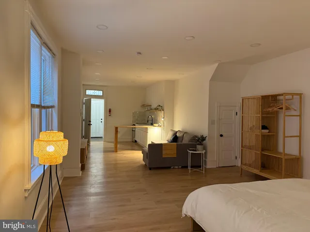 a spacious bedroom with a bed and a chandelier