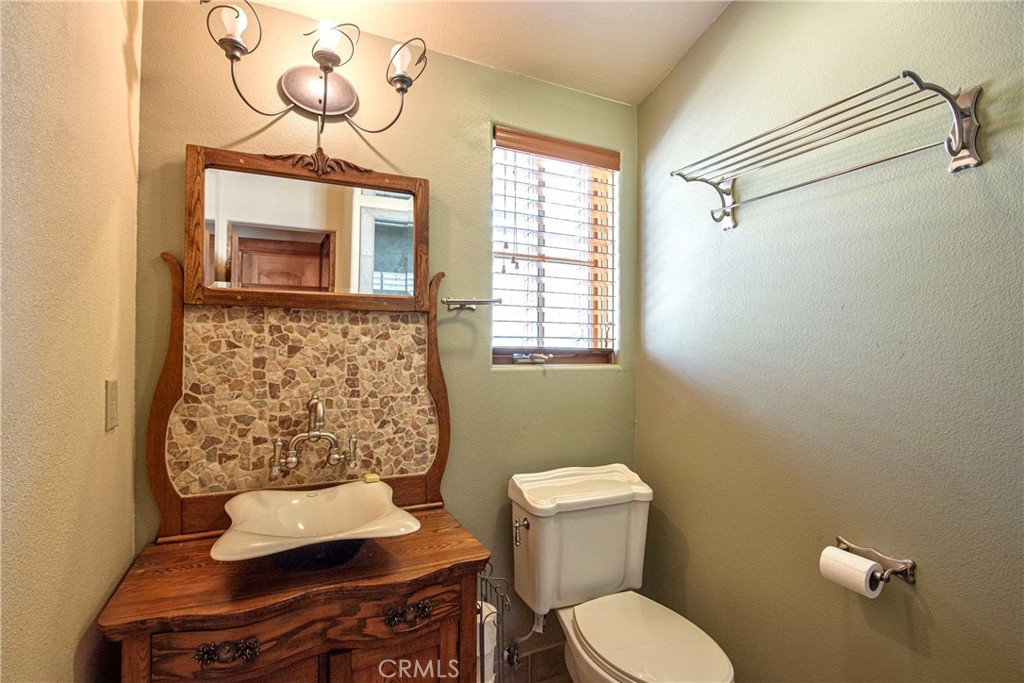 58111 Bonita Vista Road Mountain Center, CA 92561 - Photo 22 of 75 a bathroom with a toilet sink and mirror