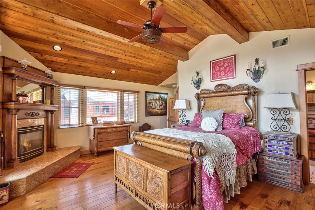 58111 Bonita Vista Road Mountain Center, CA 92561 - Photo 25 of 75 a bedroom with a bed and wooden floor