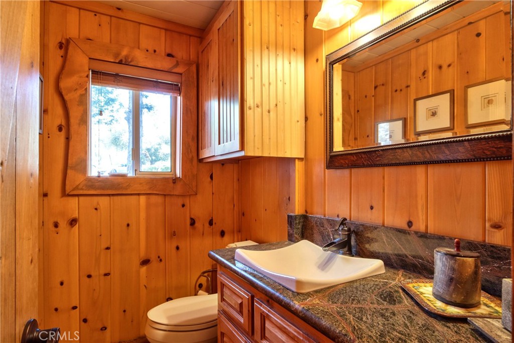 58111 Bonita Vista Road Mountain Center, CA 92561 - Photo 49 of 75 a bathroom with a granite countertop sink and a mirror