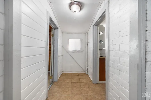 a kitchen with a sink window and cabinets