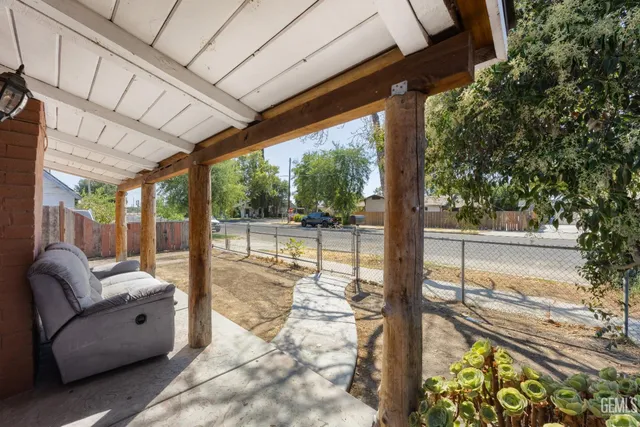 a view of the house with backyard and sitting area
