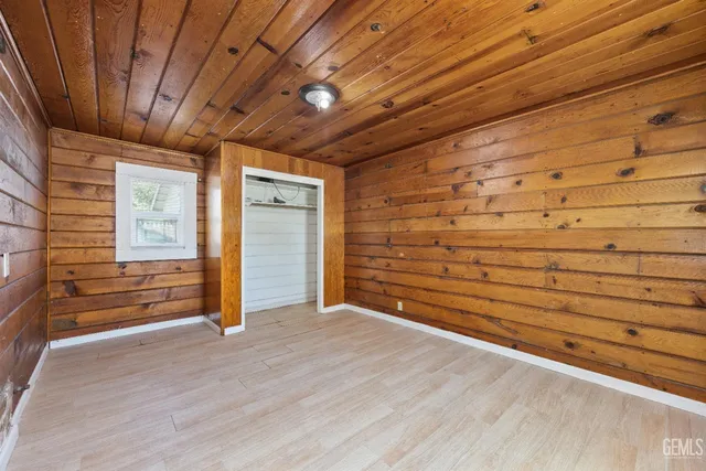 a view of an empty room and wooden floor