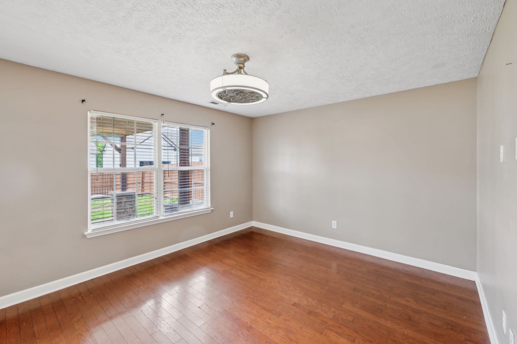325 Golfview Lane Springfield, TN 37172 - Photo 12 of 51 an empty room with wooden floor and windows