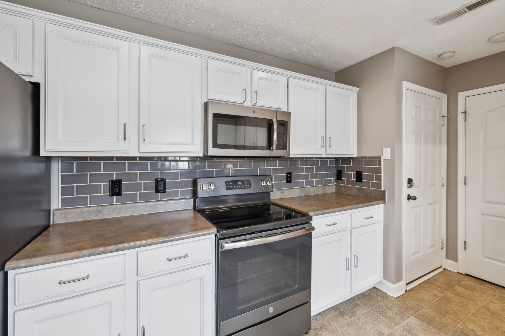 325 Golfview Lane Springfield, TN 37172 - Photo 20 of 51 a kitchen with white cabinets and white appliances
