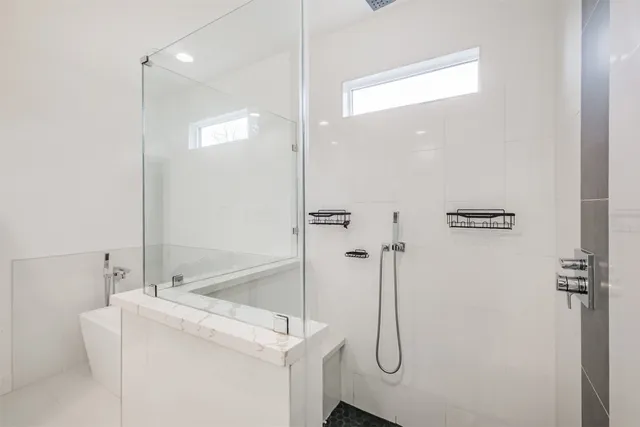 a spacious bathroom with a double vanity sink mirror and shower